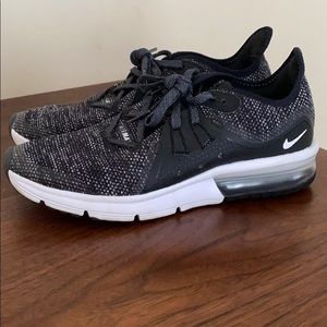 Black and White speckled Nike air maxes.